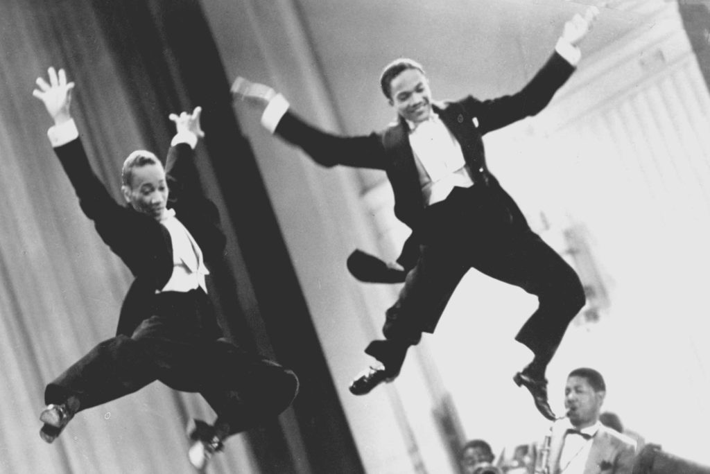 The Nicholas Brothers leaping mid air